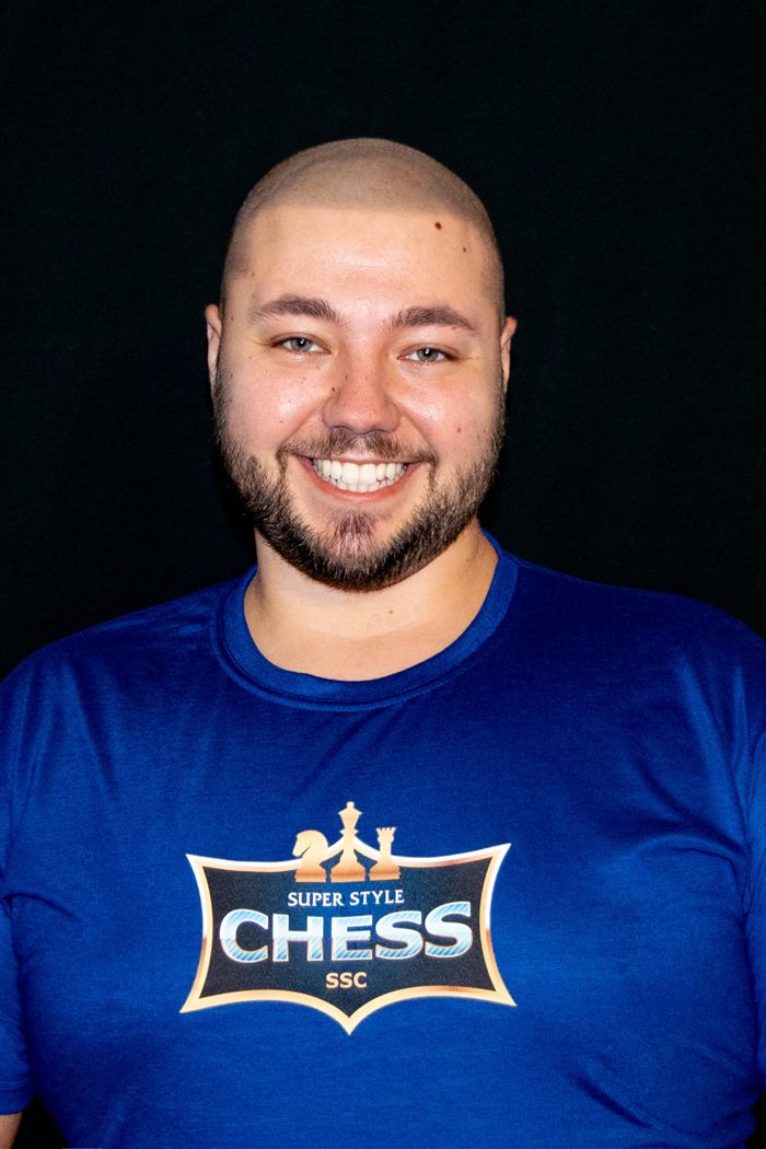 Anatoliy Goloborodko smiling in a blue Super Style Chess shirt